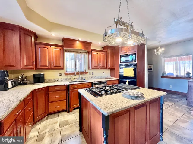 a view of a dining room with furniture a chandelier and wooden floor