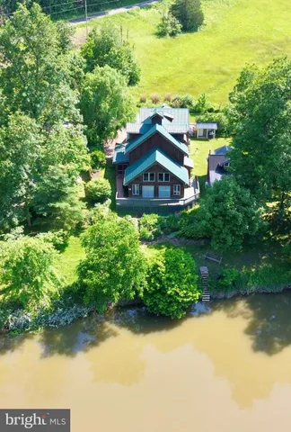 a view of a house with a yard and lake view