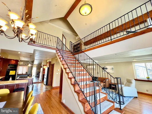 a bedroom with a bed and a ceiling fan