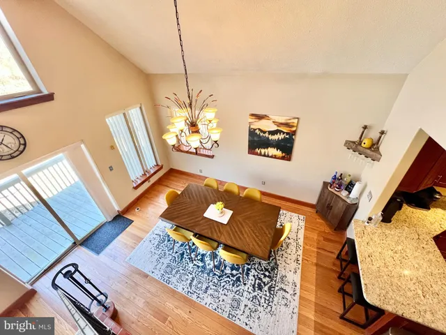 a front view of a house with a garden and tree