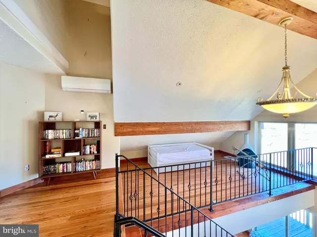 a view of entryway livingroom and hall with wooden floor