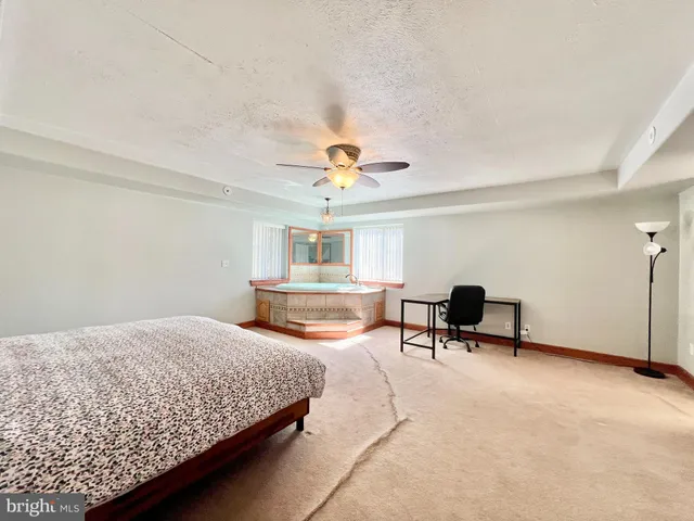 a room with a bed and a large window