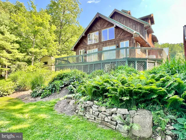a view of a house with a yard and plants