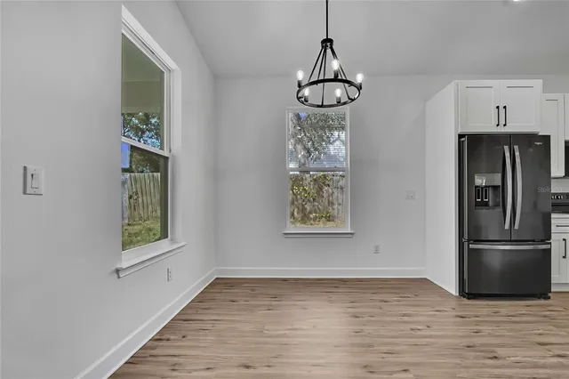 a view of a dining room with furniture wooden floor and chandelier