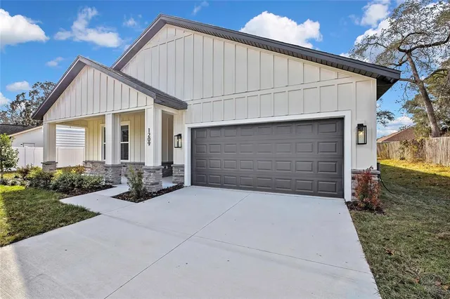 a view of house with backyard and garden