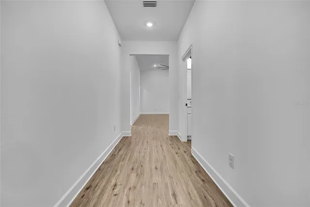 a view of a room with wooden floor and staircase