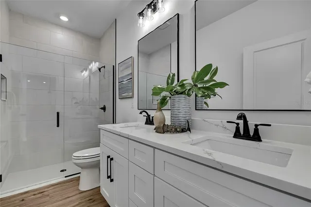 a view of an empty room with wooden floor and closet