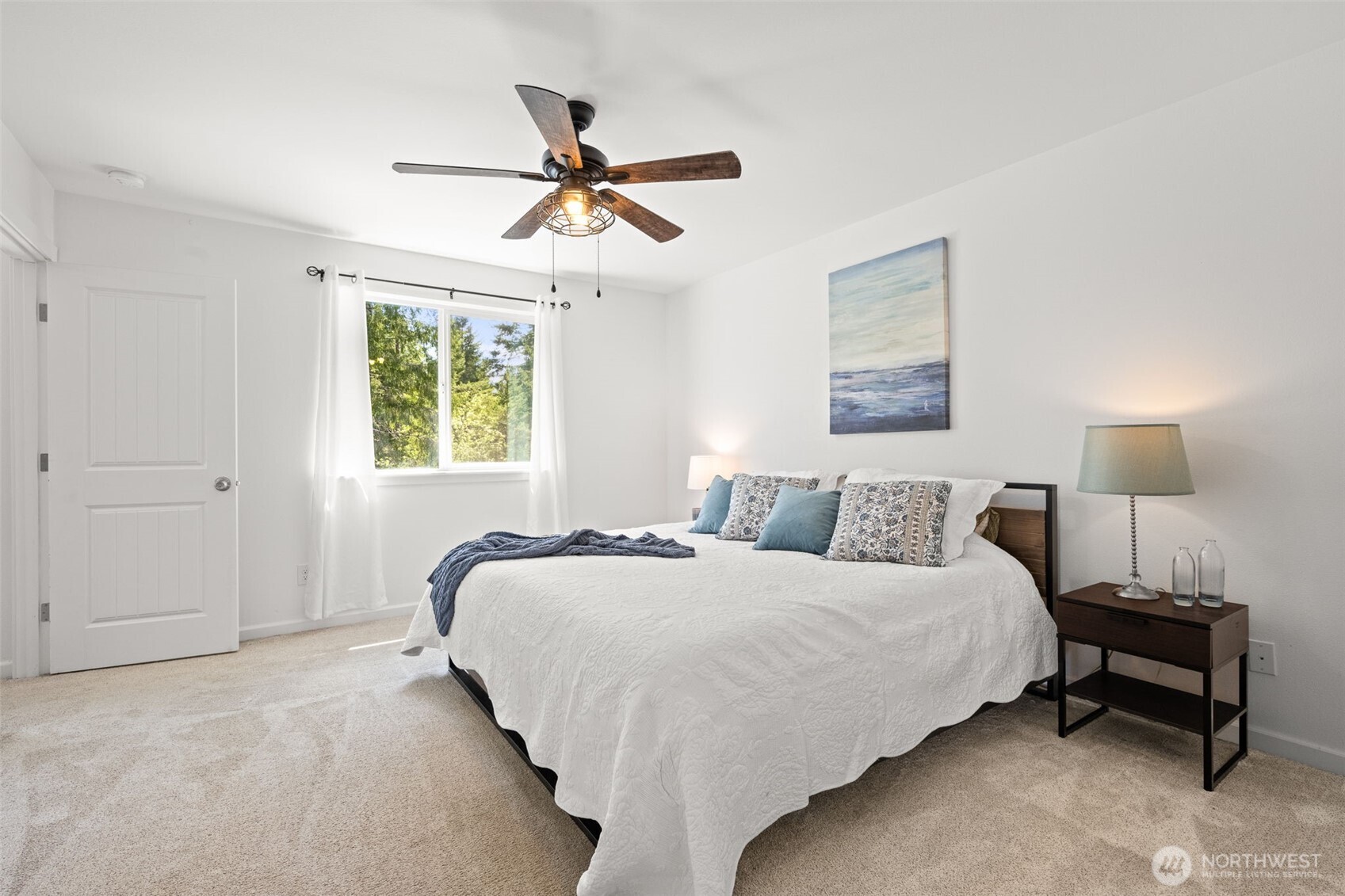 401 East Sunset Ridge Road Union, WA 98592 - Photo 16 of 37 a bedroom with a bed and a chandelier