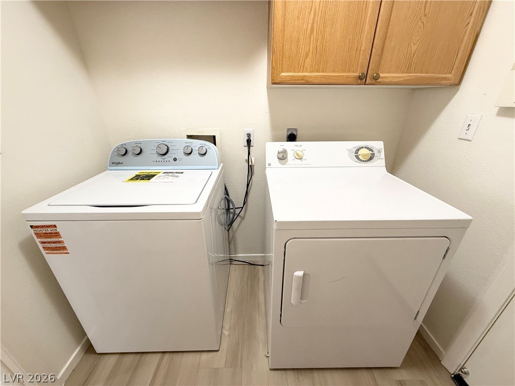 8870 Haviland Road Las Vegas, NV 89123 - Photo 18 of 24 Functional laundry nook with washer and dryer, complete with overhead storage.