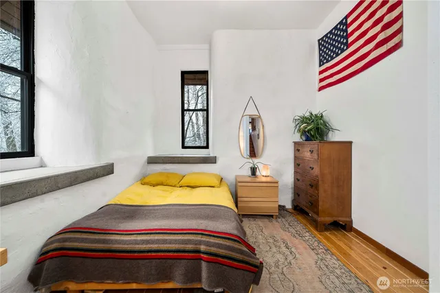 a bedroom with a bed and a window