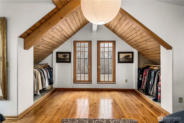 a view of front door with wooden floor and a large window