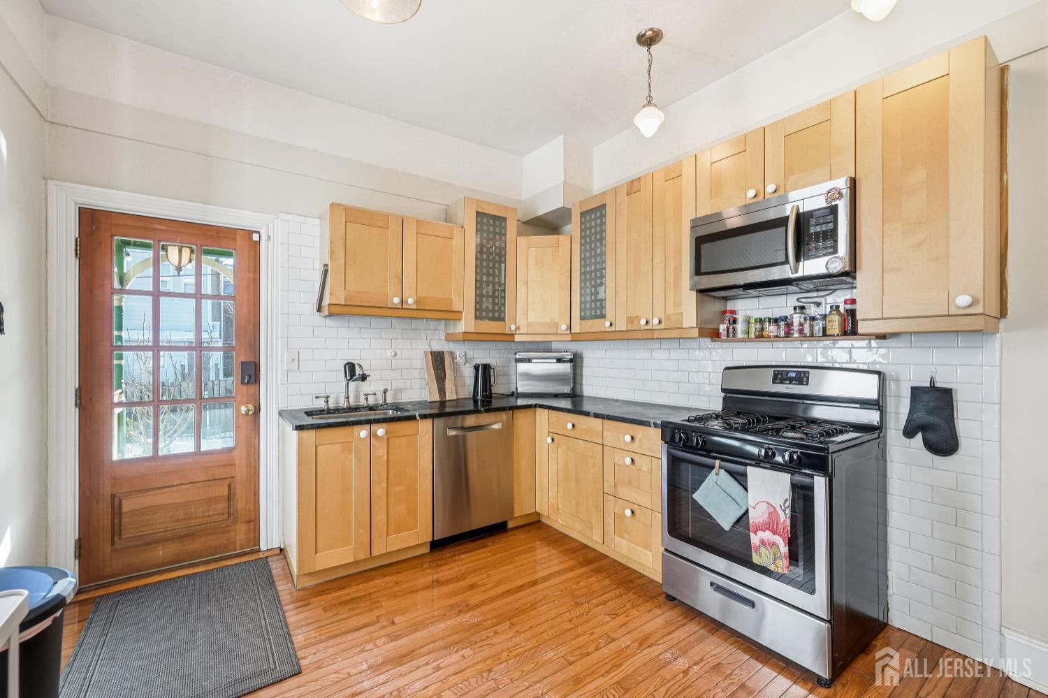346 East Union Street Burlington, NJ 08016 - Photo 17 of 48 a kitchen with stainless steel appliances granite countertop a stove sink and cabinets