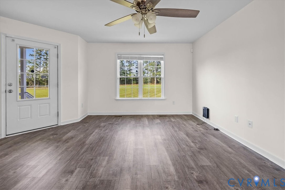 11325 Webb Road Disputanta, VA 23842 - Photo 5 of 32 wooden floor in an empty room with a window