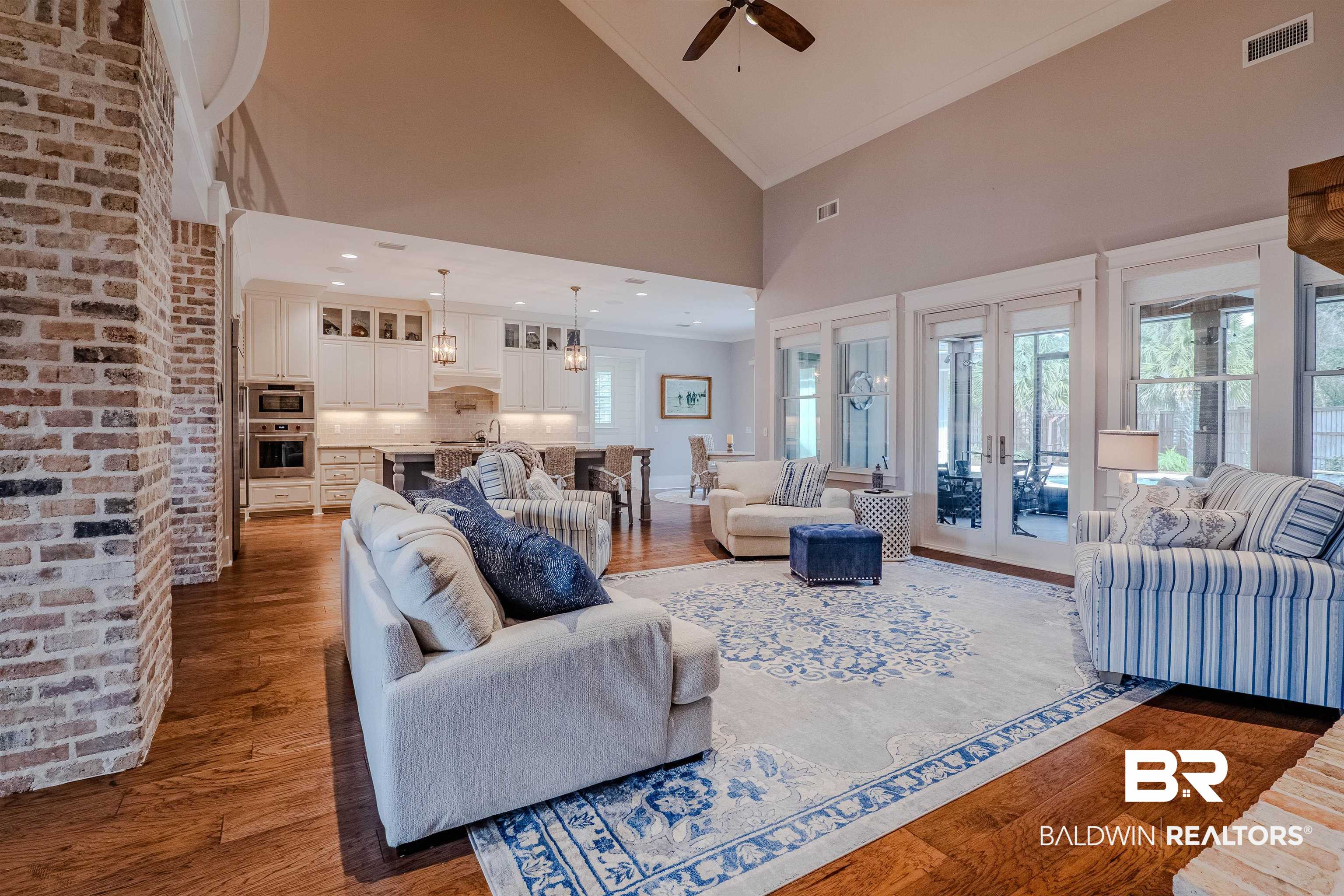 708 Manning Place Fairhope, AL 36532 - Photo 19 of 58 Living room with crown molding, dark wood-type flooring, a wealth of natural light, and high vaulted ceiling