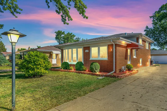 a front view of a house with porch and garden
