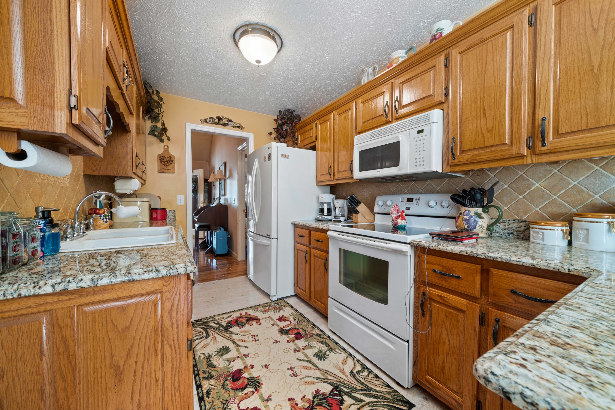425 Fowler Ford Road Portland, TN 37148 - Photo 6 of 40 a kitchen with stainless steel appliances granite countertop a stove sink and cabinets