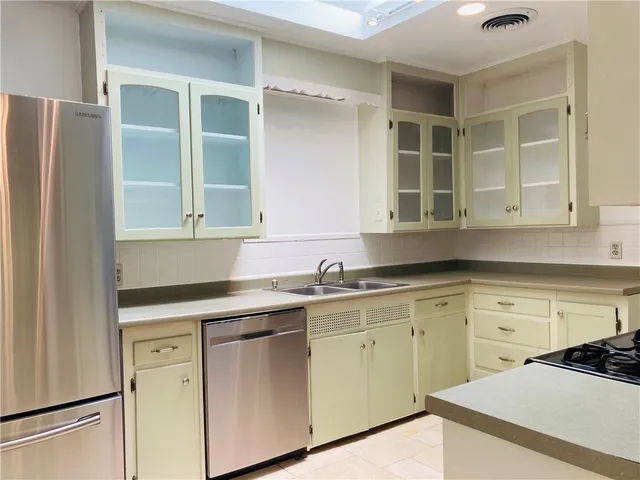 a kitchen with stainless steel appliances a refrigerator and a sink