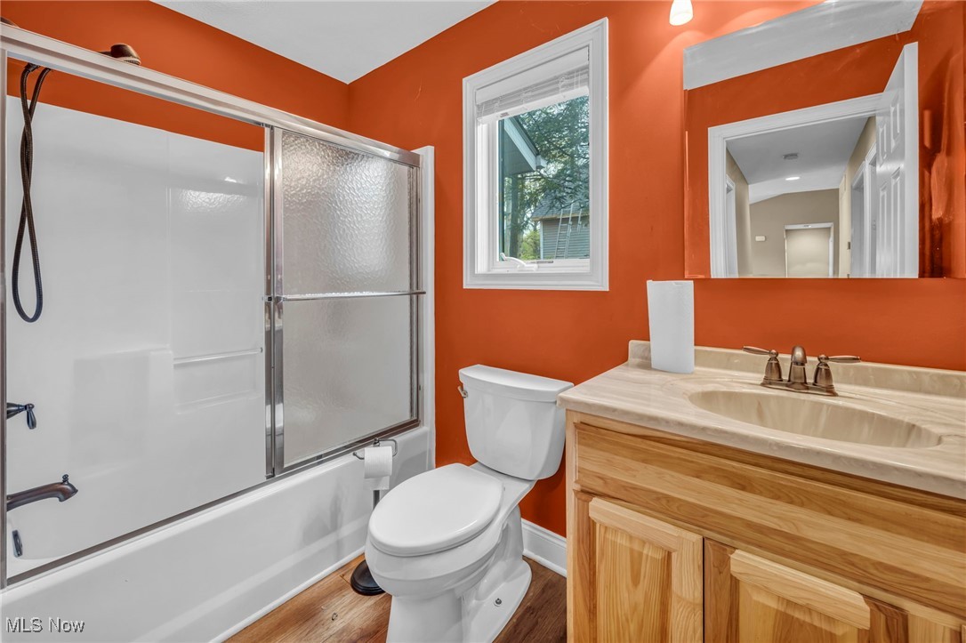 800 Bell Road Chagrin Falls, OH 44022 - Photo 21 of 35 Full bath with wood finished floors, toilet, bath / shower combo with glass door, vanity, and baseboards