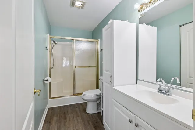 a bathroom with a sink toilet and shower