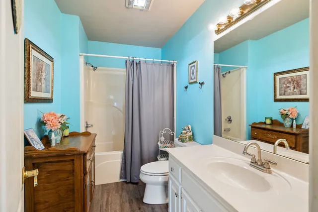 a bathroom with a sink vanity mirror and toilet