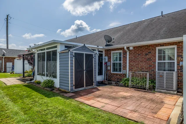 a view of a house with backyard and porch