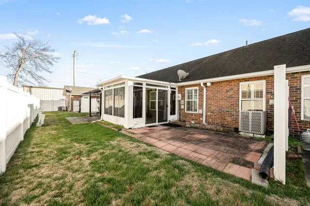 a view of a house with backyard and porch