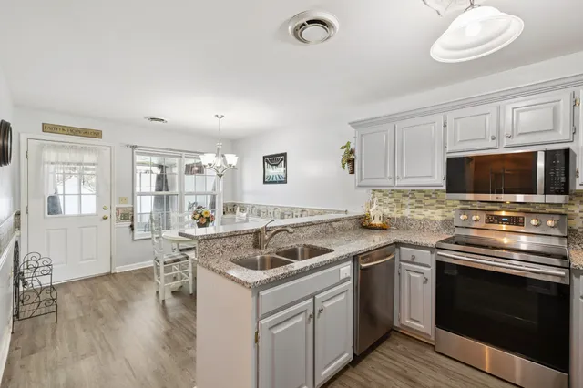a kitchen that has a sink and a stove top oven