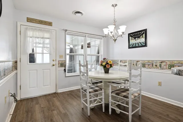 a view of a dining room with furniture and chandelier