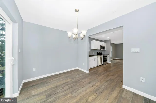 a view of a kitchen with wooden floor and a kitchen