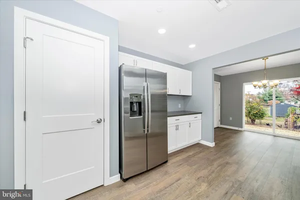 a kitchen with a refrigerator and a stove