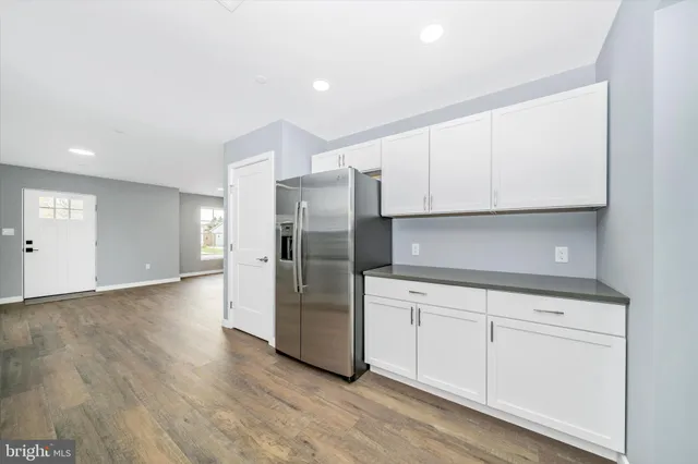a kitchen with stainless steel appliances a refrigerator sink and cabinets