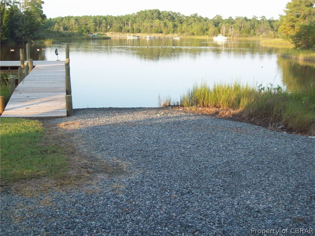 195 Hurst Neck Road Onemo, VA 23130 - Photo 5 of 30 a view of a lake with a yard and trees