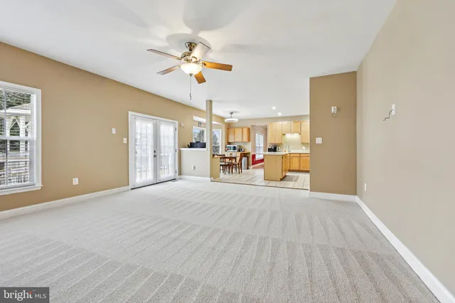 a view of a livingroom with a furniture chandelier and a window