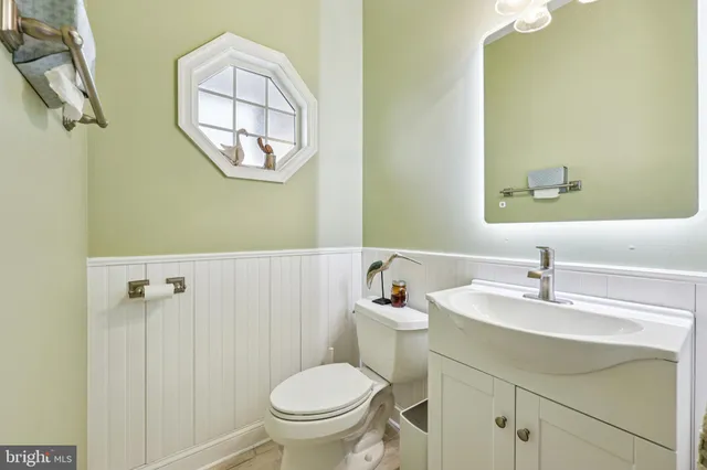 a bathroom with a sink toilet and a mirror