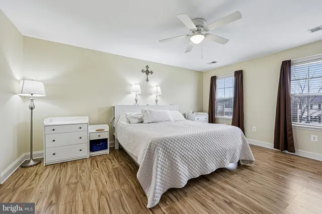 a spacious bedroom with a bed and a chandelier