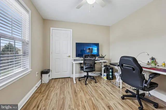 a view of a workspace with furniture and a window