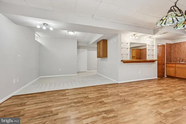 a view of an empty room with a kitchen