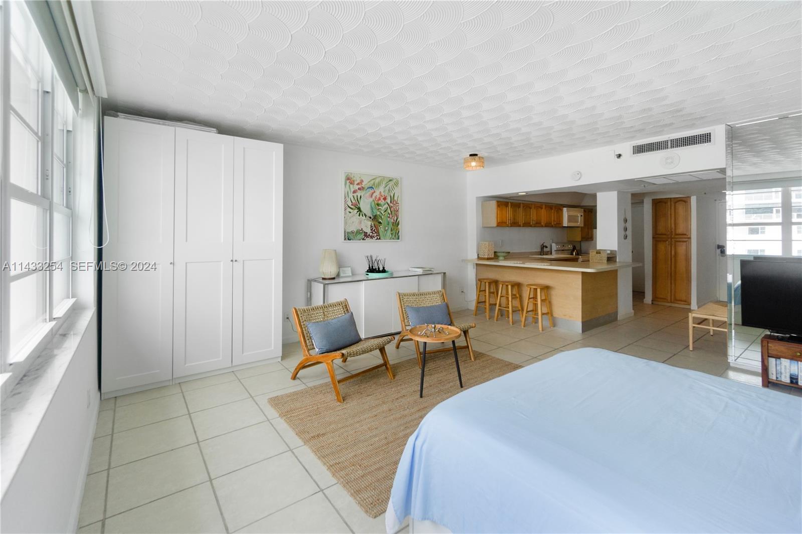 100 Lincoln Road, Unit 1039 Miami Beach, FL 33139 - Photo 5 of 26 a bedroom with furniture a flat screen tv and a fireplace