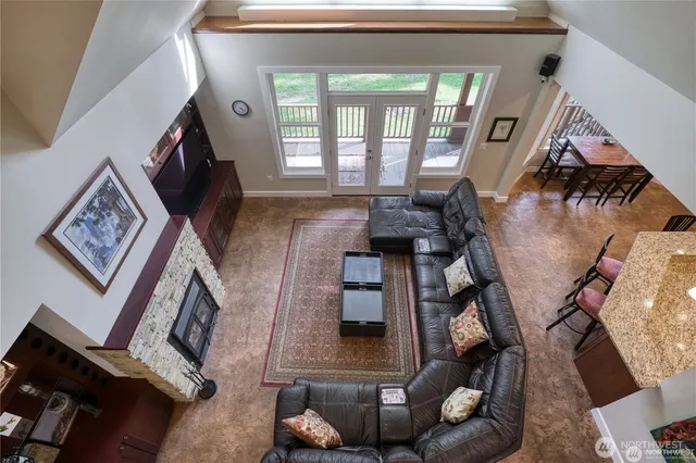 a view of a hallway with wooden floor and stairs