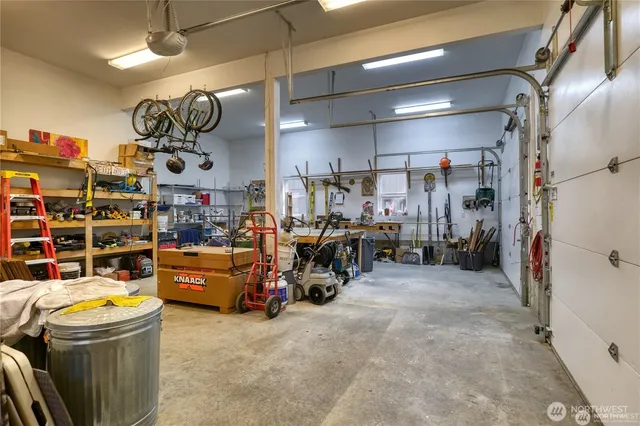 a large kitchen with a sink appliances and cabinets