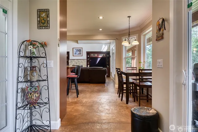 a living room with furniture a dining table and a painting