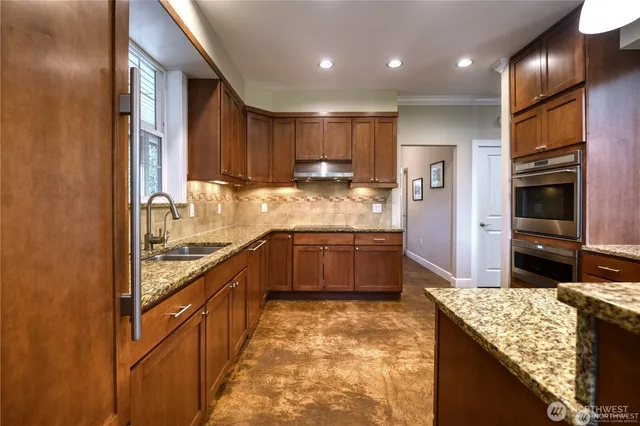 a large kitchen with stainless steel appliances granite countertop a large counter top