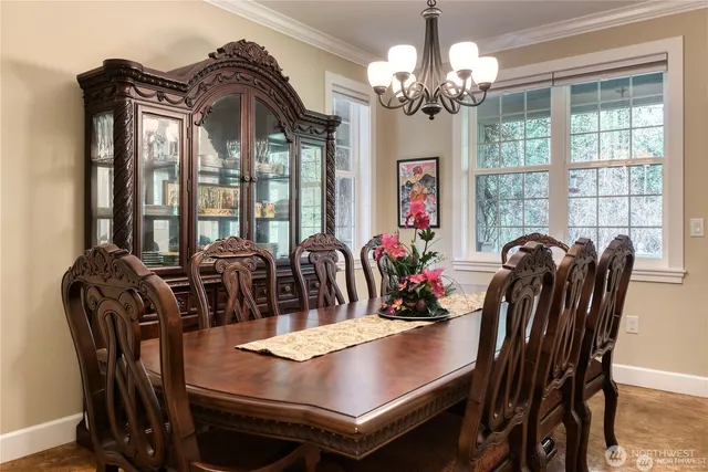 a view of a dining room with furniture and chandelier