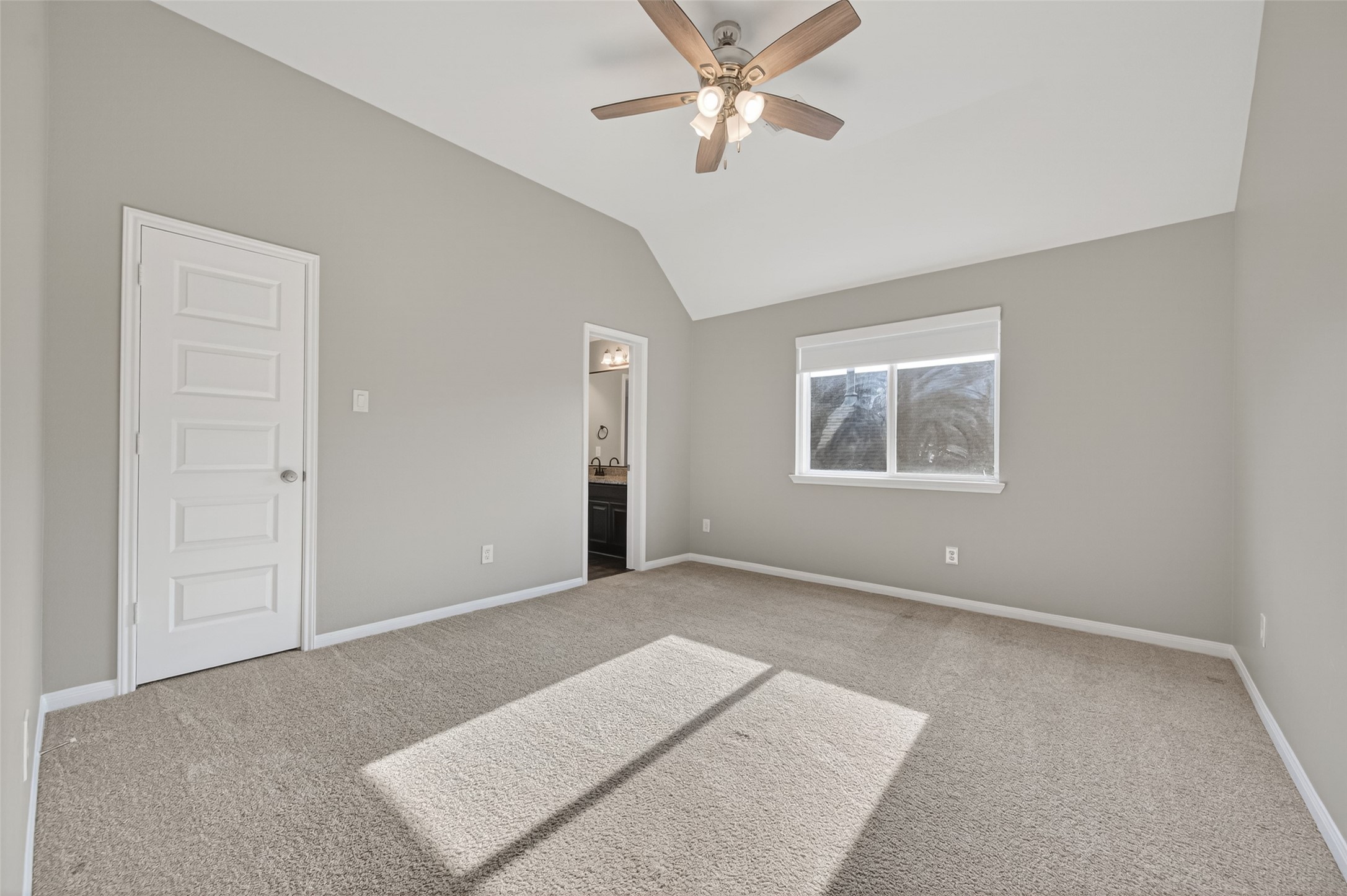 7003 Bristol Memorial Drive Spring, TX 77379 - Photo 40 of 40 Spacious secondary bedroom in this Spring TX 77379 home featuring vaulted ceilings, plush carpeting, and abundant natural light. The generous layout provides flexibility for a variety of furniture configurations, while the walk-in closet adds valuable storage. Direct access to the Jack-and-Jill bathroom enhances functionality and convenience. Located on the upper level, this well-sized bedroom complements the smart, multi-bedroom floorplan in this move-in ready home