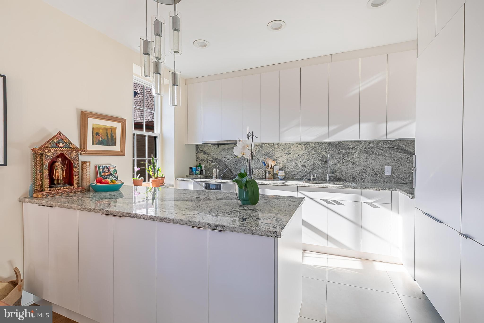1517 30th Street Northwest, Unit C11 Washington, DC 20007 - Photo 16 of 33 a kitchen with stainless steel appliances granite countertop a sink and a refrigerator