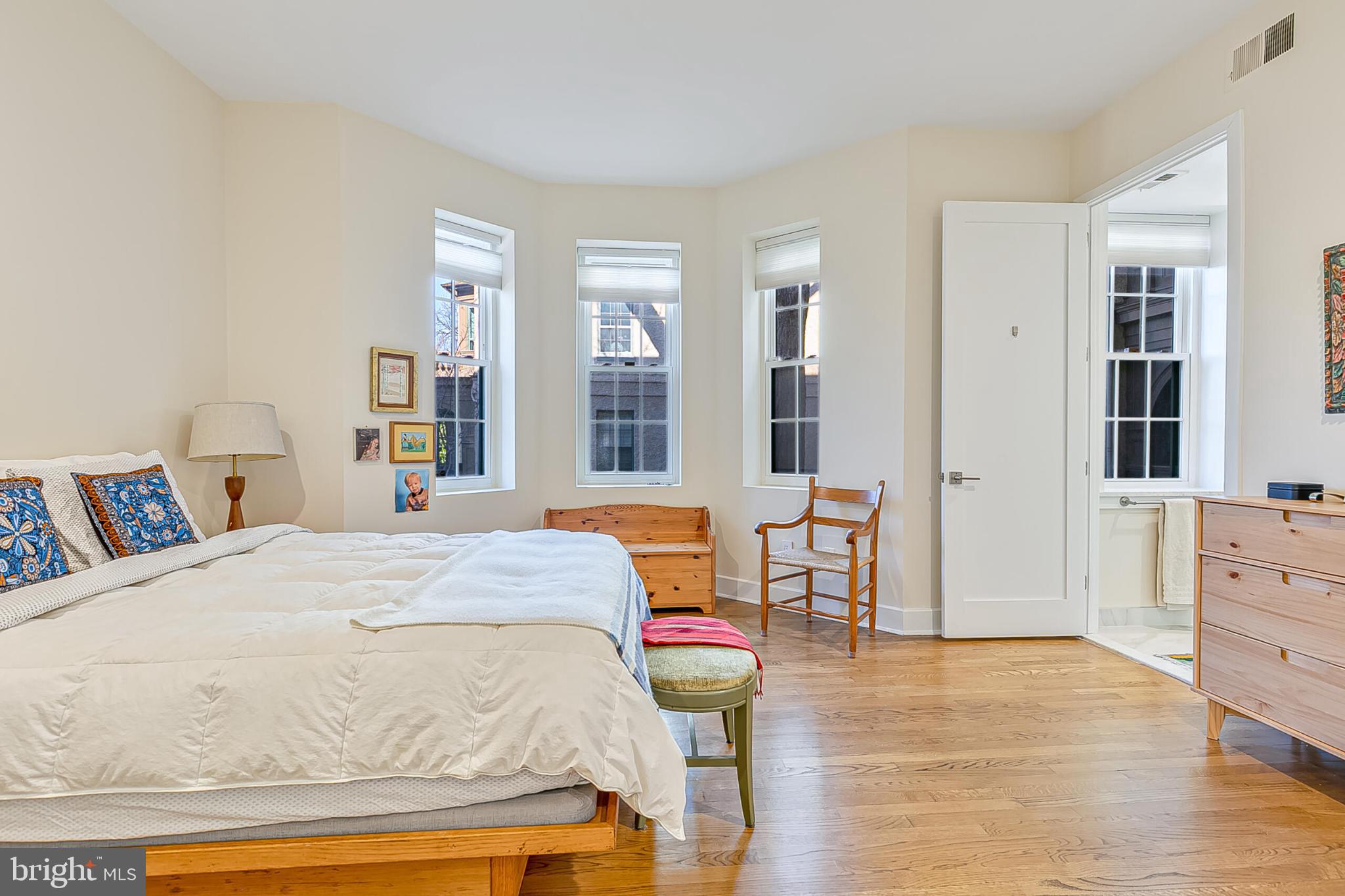 1517 30th Street Northwest, Unit C11 Washington, DC 20007 - Photo 19 of 33 a bedroom with a bed and wooden floor