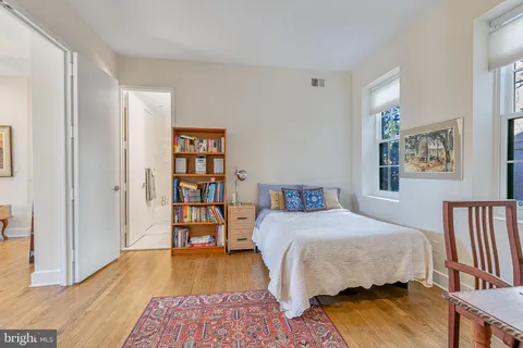 a bedroom with a bed and a book shelf