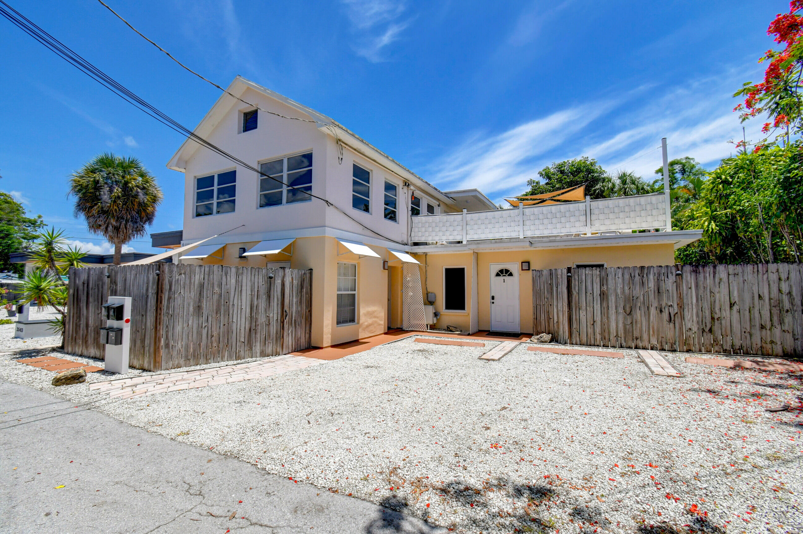 4 Gibbs Road, Unit 1 Boynton Beach, FL 33435 - Photo 2 of 43 a front view of a house with a yard and garage