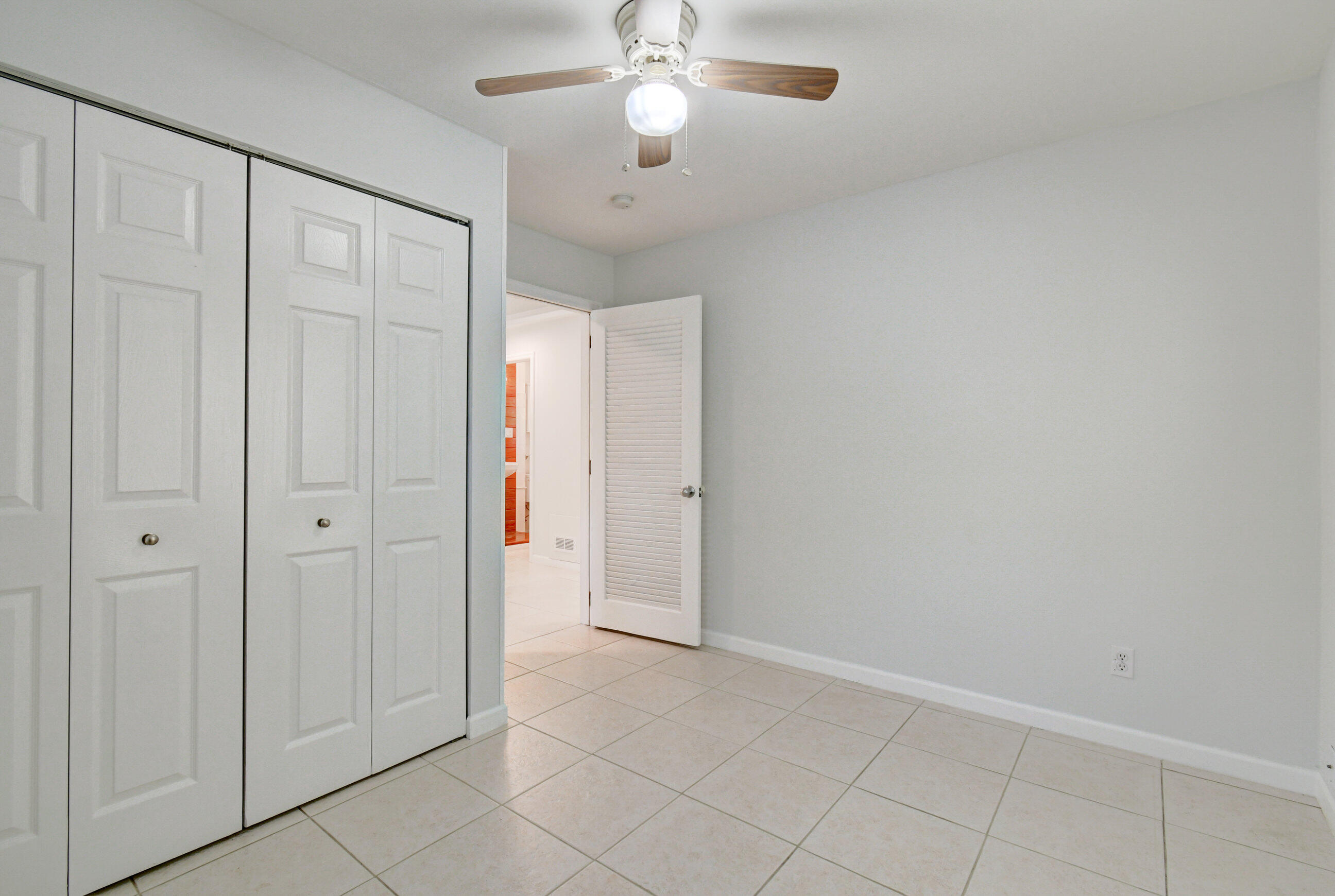4 Gibbs Road, Unit 1 Boynton Beach, FL 33435 - Photo 26 of 43 an empty room with closet and a chandelier fan