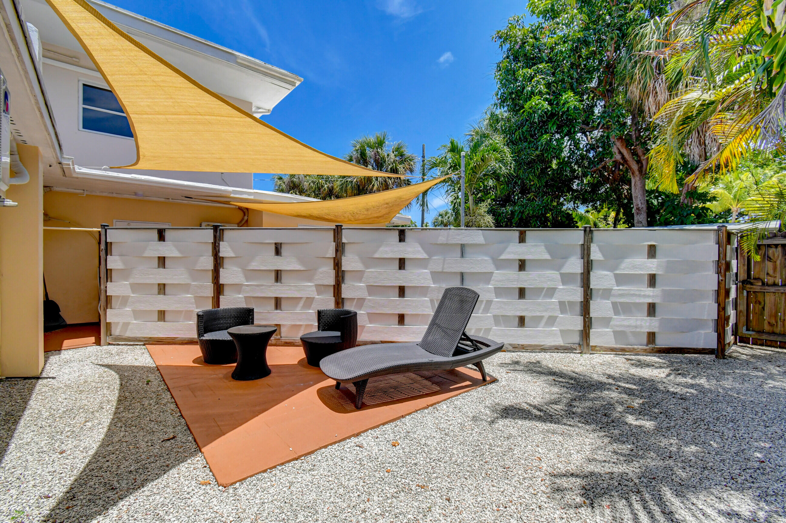 4 Gibbs Road, Unit 1 Boynton Beach, FL 33435 - Photo 29 of 43 a view of a patio with couches and potted plants
